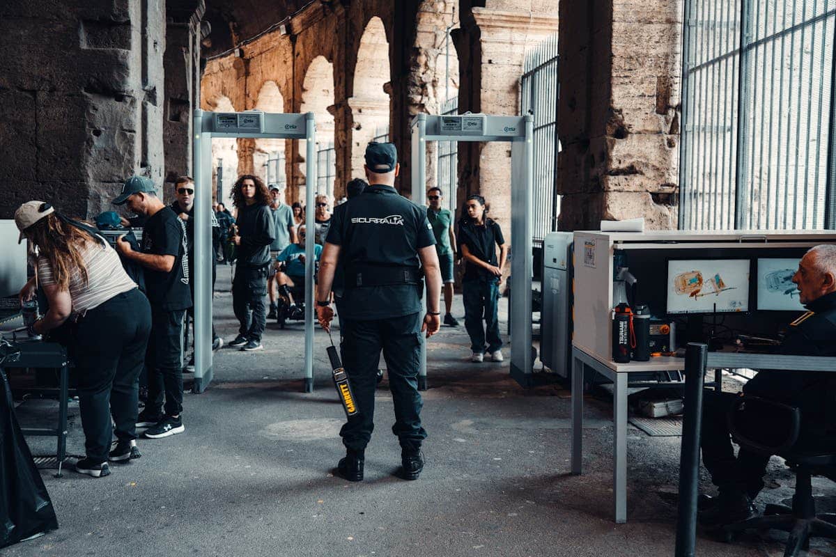 Security checkpoint at entrance — bag screening vs no screening