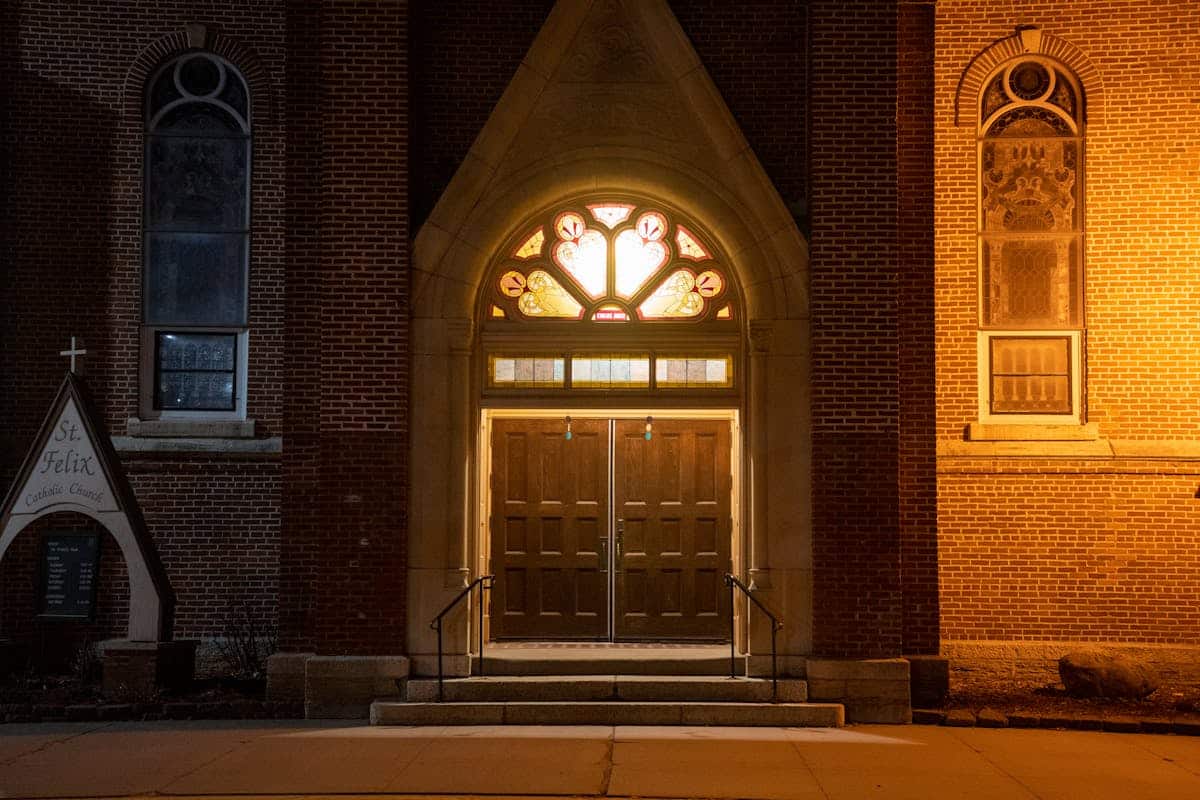 Church wooden door entrance — lock doors mid-service vs open doors