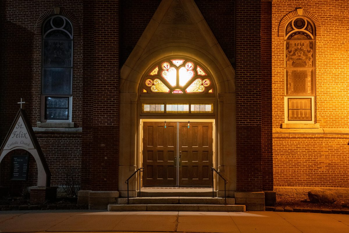 Church wooden door at night — houses of worship attendance policy decision
